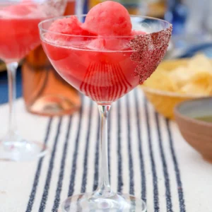 Watermelon frosé cocktail in a sumac-sugar-rimmed glass