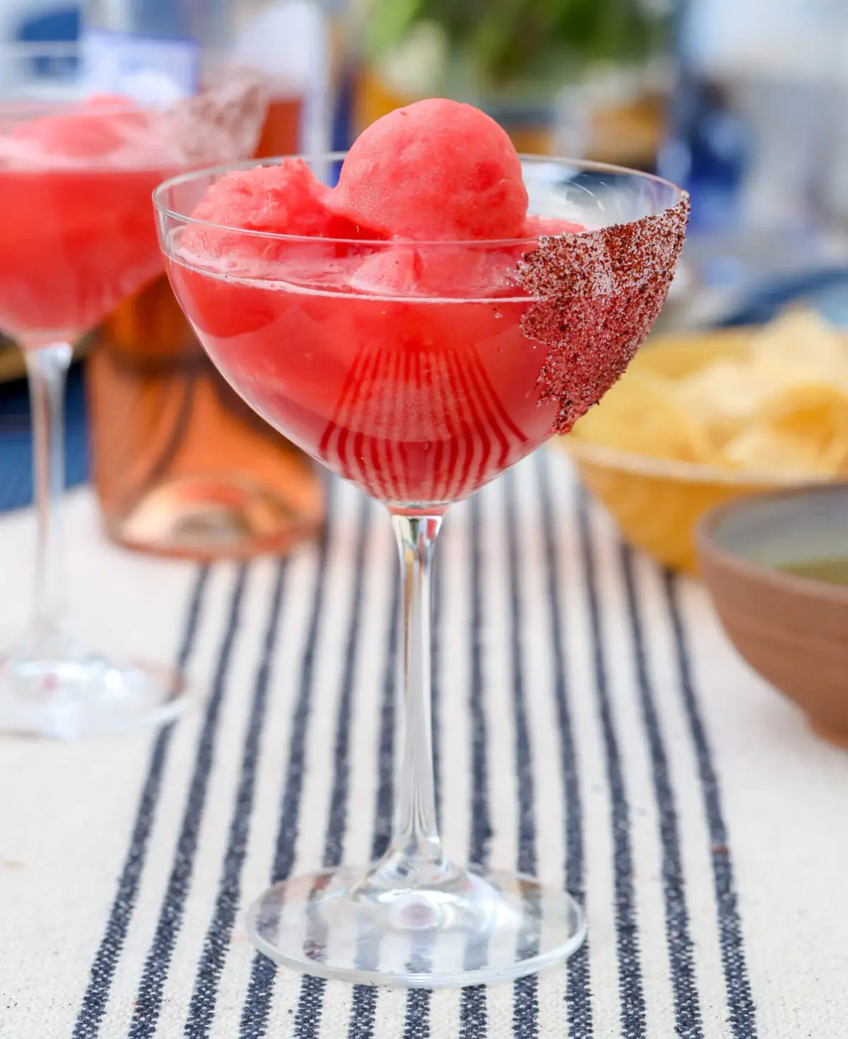 Watermelon frosé cocktail in a sumac-sugar-rimmed glass