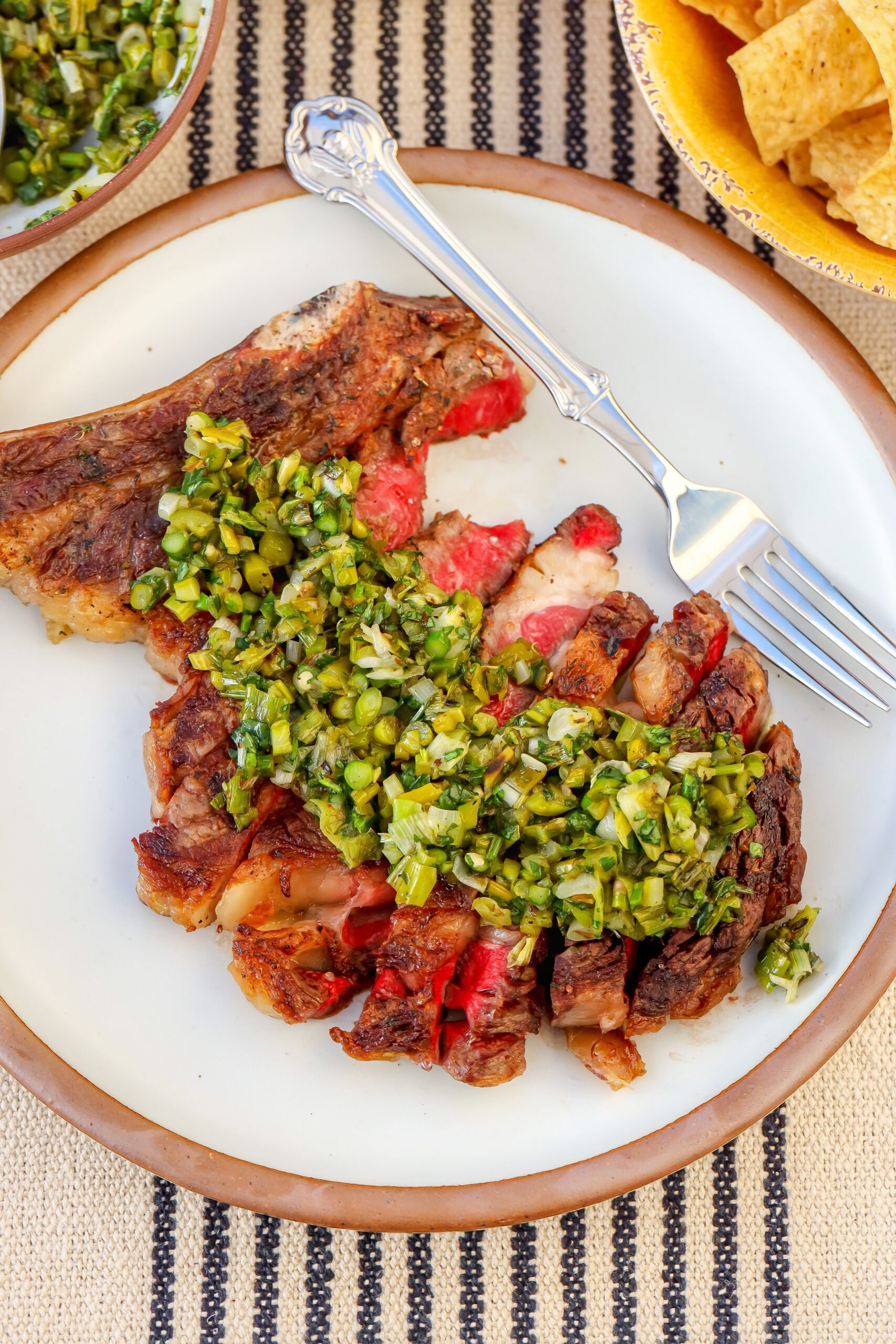Mexican steak recipe with grilled bone-in ribeye and charred asparagus-serrano salsa