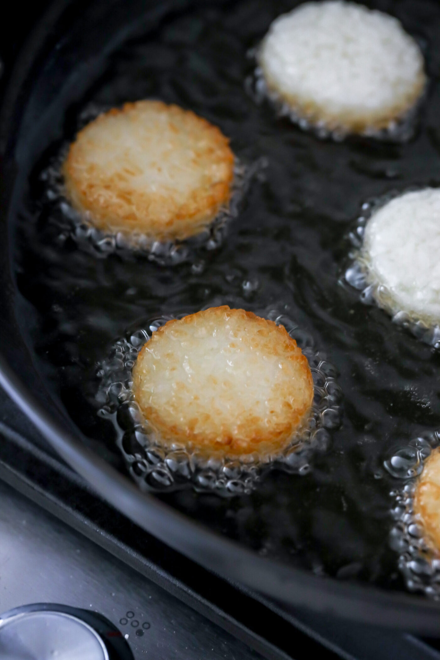 Crispy rice frying in hot oil until golden