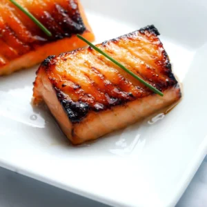 Miso salmon Nobu copycat fillets with a caramelized amber crust and tender pink interior, garnished with chives.