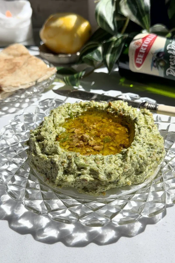 10-minute whipped feta with honey and crushed pistachios in a vintage glass bowl, served with pita bread.