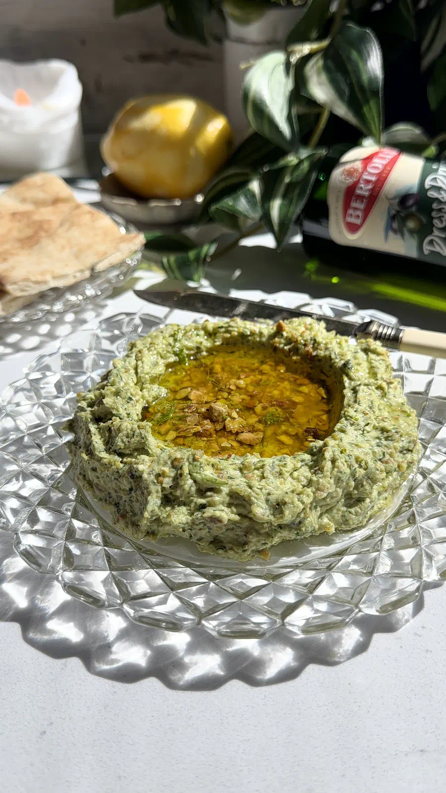 10-minute whipped feta with honey and crushed pistachios in a vintage glass bowl, served with pita bread.