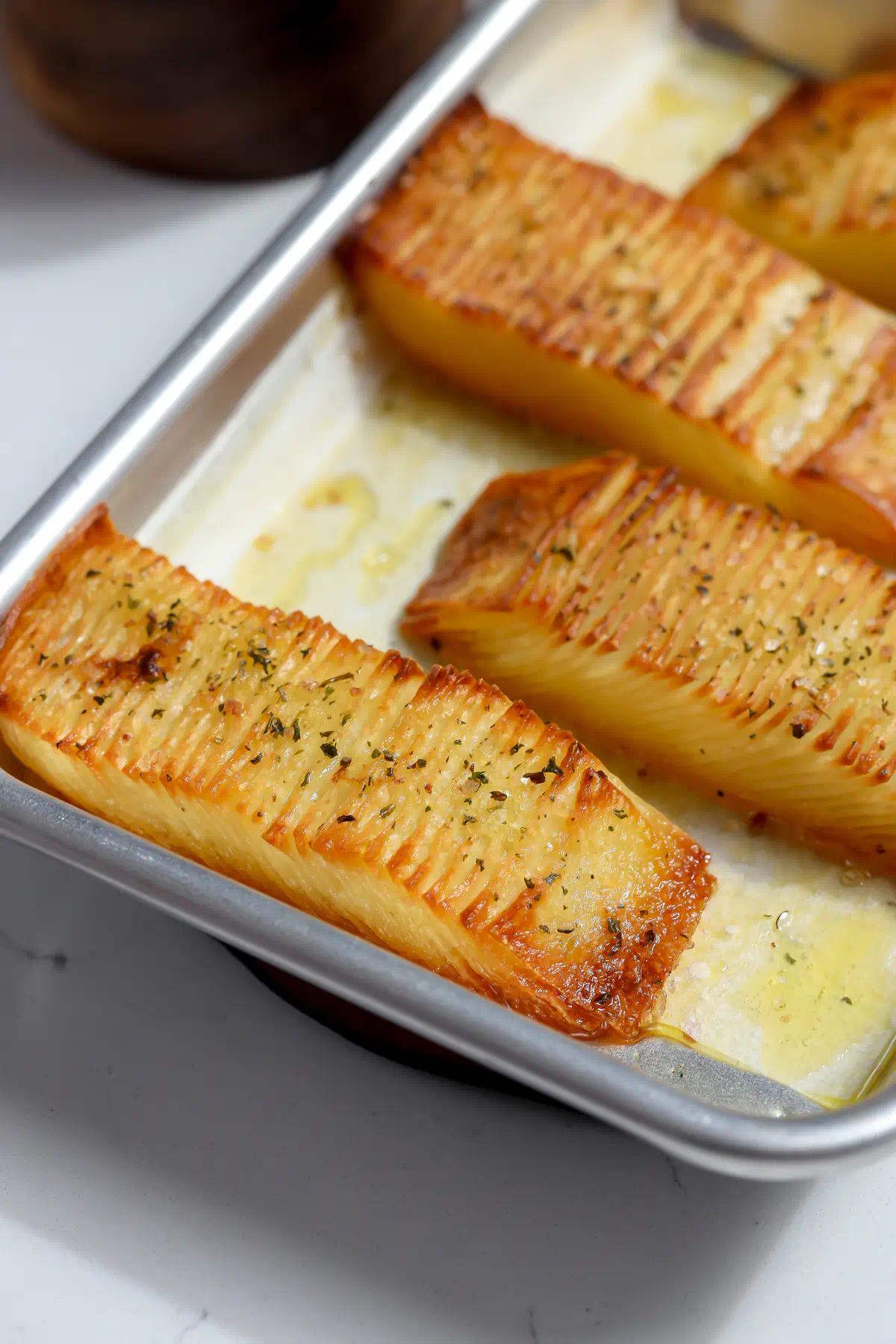Golden baked domino potatoes with crisp browned edges on a sheet pan