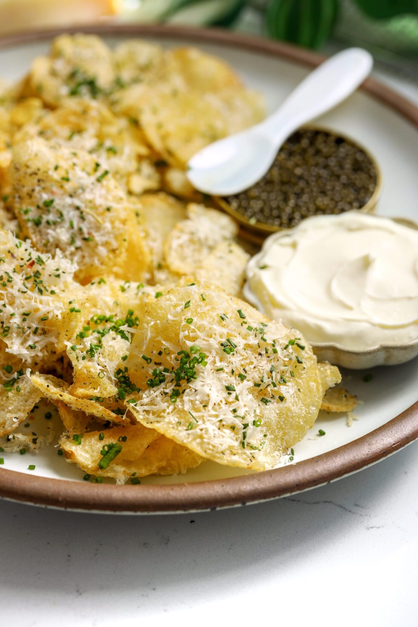 Kettle chips with parm cheese and homemade seasonings next to créme fraîche and caviar.
