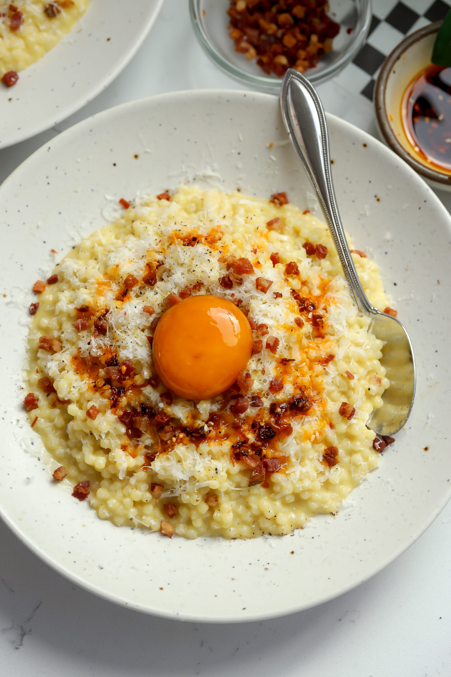 easy Carbonara Pastina with pancetta and a cured egg yolk on top.