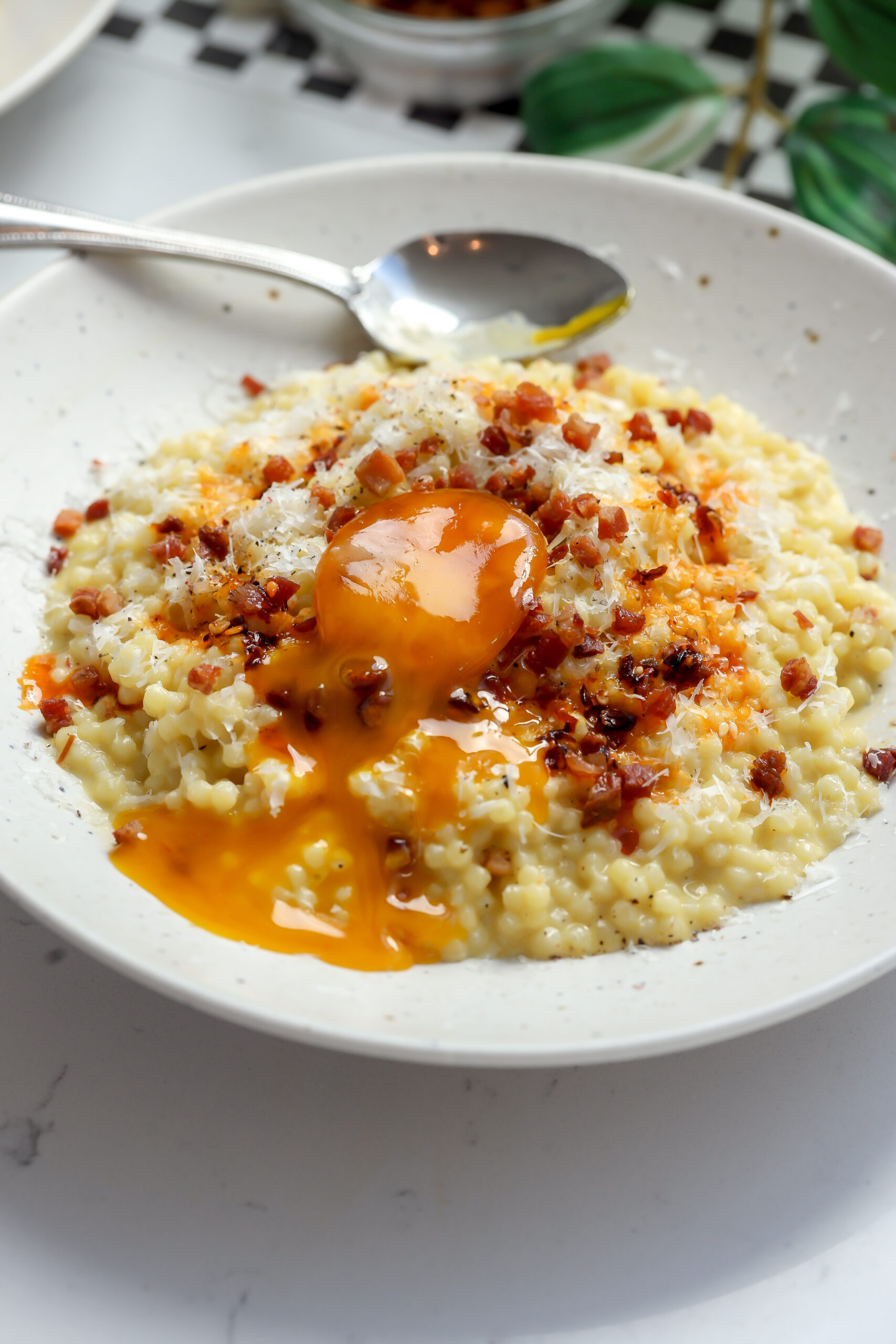 easy Carbonara Pastina with pancetta and a cured egg yolk on top.