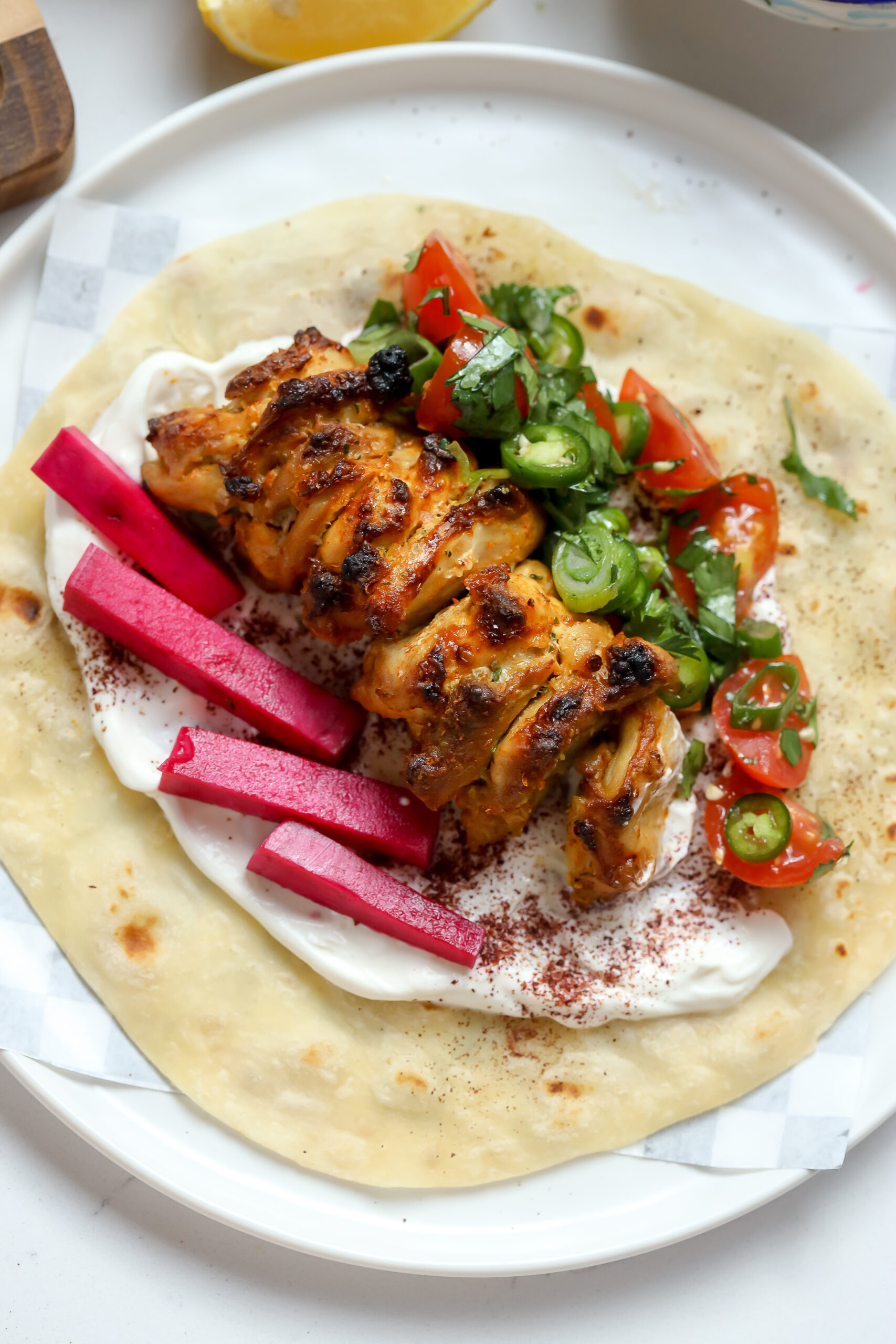 Chicken Shawarma Tacos in a homemade tortilla with labneh tahini sauce.