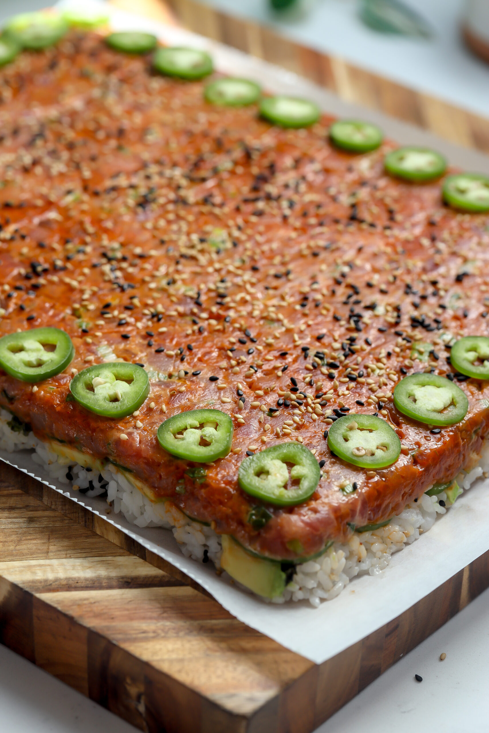 spicy salmon sushi bowl recipe but made in a board form for a large group.
