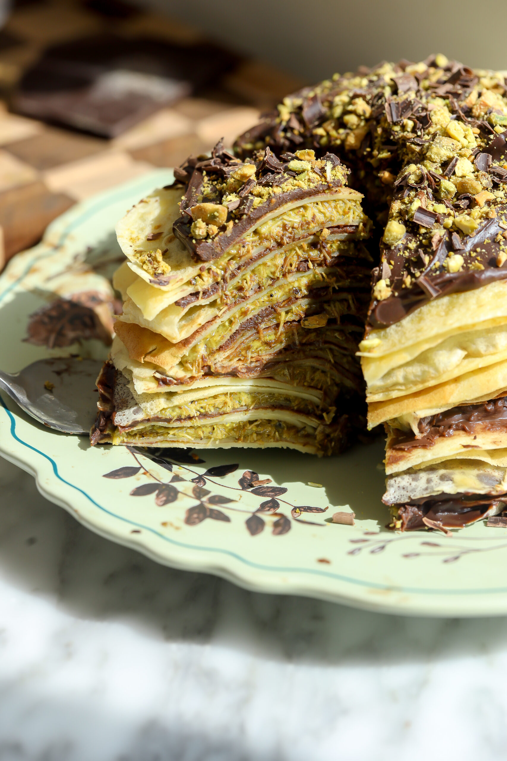Dubai Chocolate crepe cake recipe with a piece cut out
