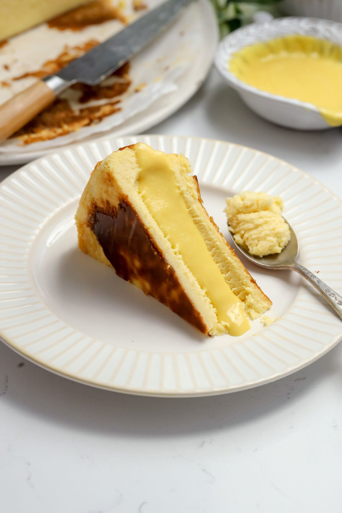 A slice of caramelized burnt Basque corn cheesecake with a creamy center.