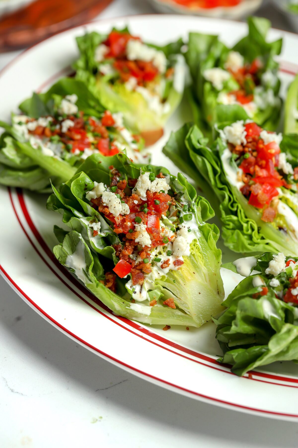 A wedge of romaine lettuce with blue cheese dressing, bacon bits, tomatoes, it has the best flavor and is handheld! Memorial Day