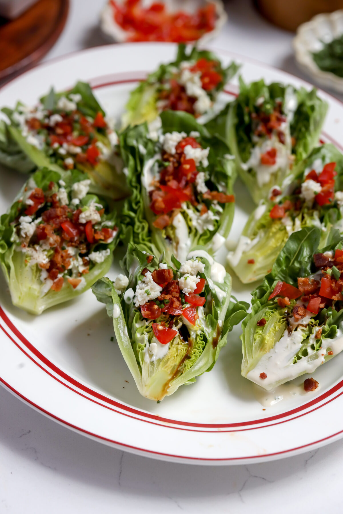 A wedge of romaine lettuce with blue cheese dressing, bacon bits, tomatoes, it has the best flavor and is handheld!