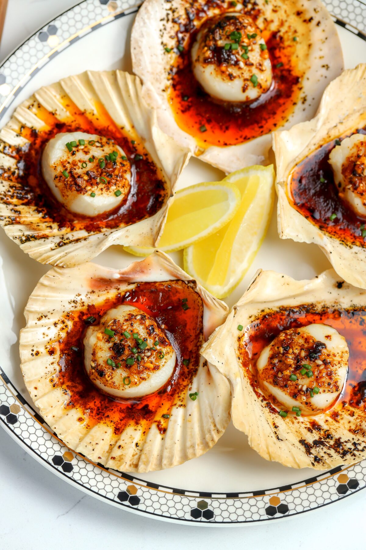 tender and juicy scallop coated in a spicy and sweet butter and then broiled to a golden perfection