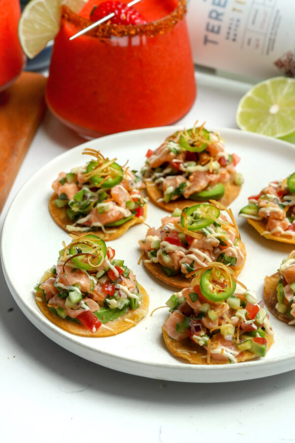 This is a recipe for Salmon Ceviche Tostadas and they are laid out of a plate, delicious and ready to eat.
