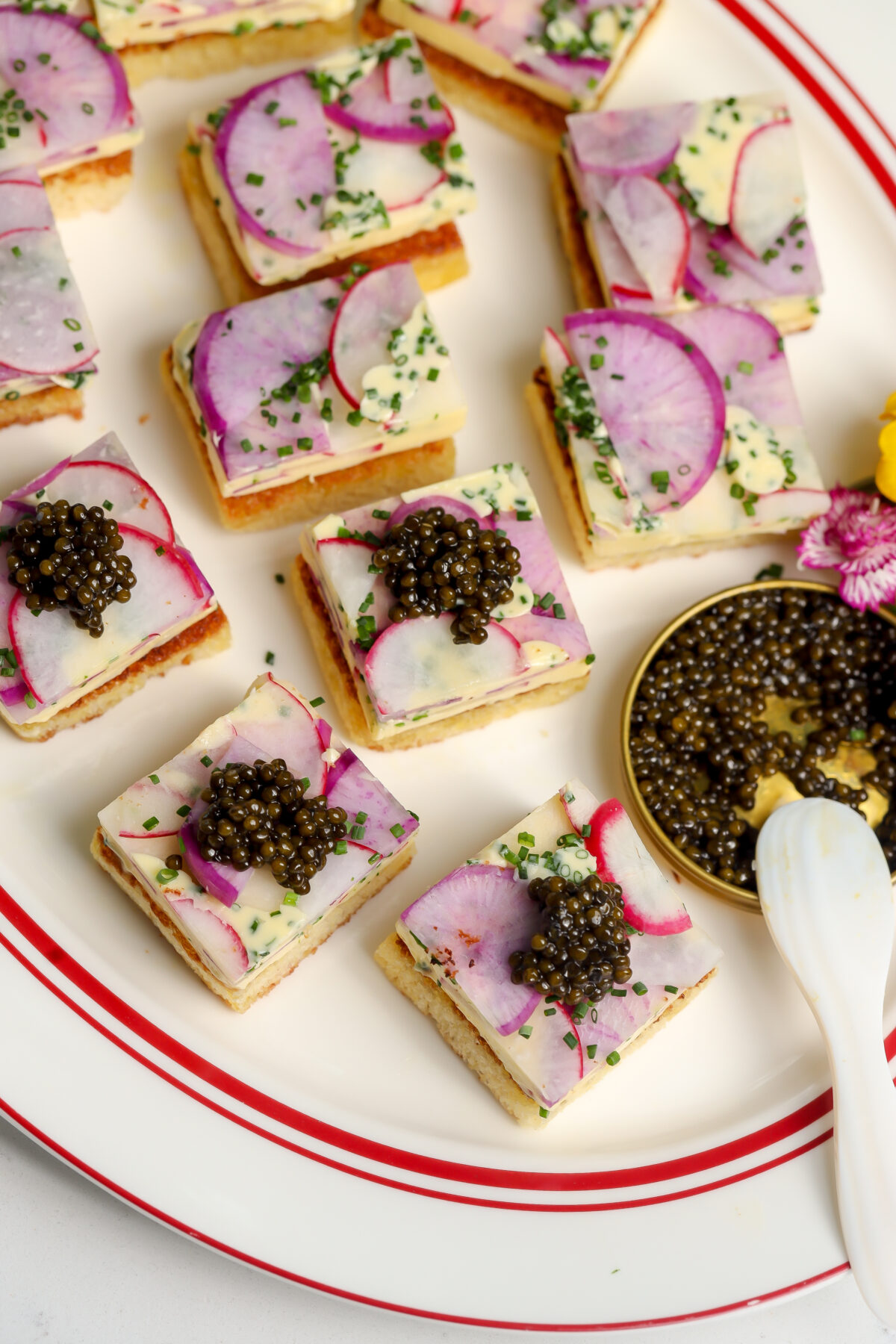 Butter Radish Tea Sandwiches with caviar sitting next to them. Perfect for a tea party.
