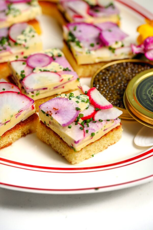Butter Radish Tea Sandwiches with caviar sitting next to them. Perfect for a tea party.