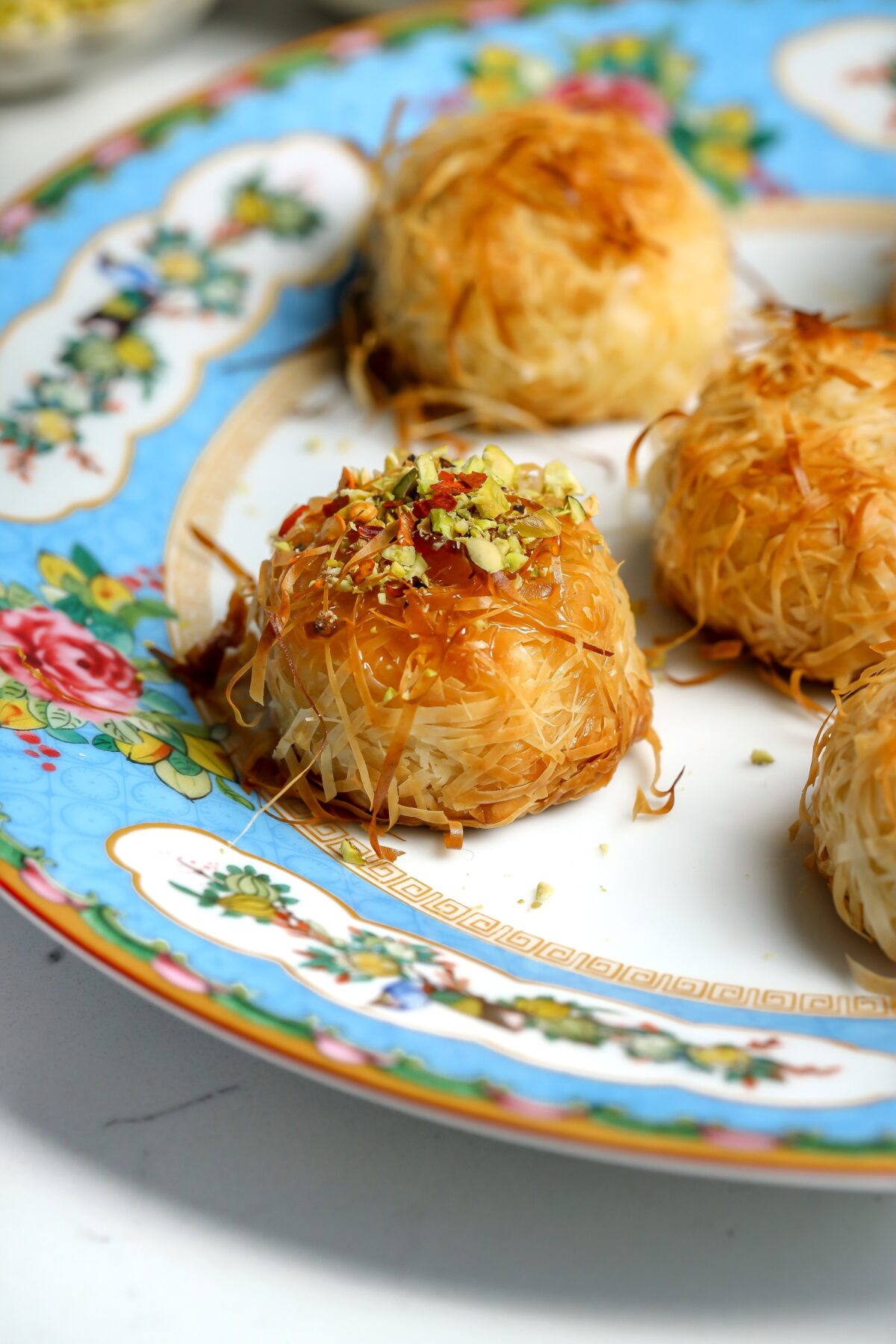 Straight of of the oven, crispy baked brie bites wrapped in phyllo dough and covered in butter.