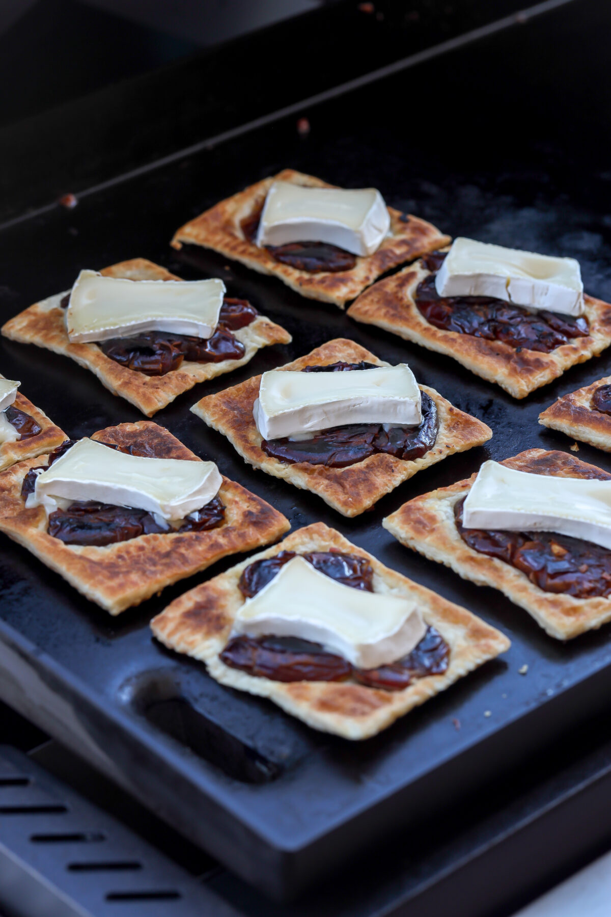 Sweet date fruit caramelized with melty brie cheese on a buttery flaky puff pastry on crisping on a griddle.