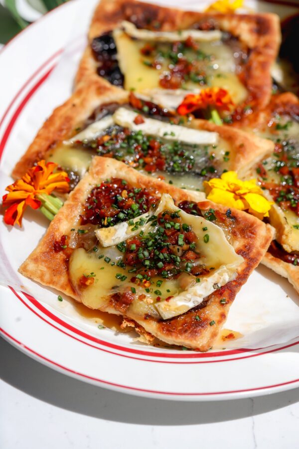Sweet date fruit caramelized with melty brie cheese on a buttery flaky puff pastry making a delicious upside-down tart.