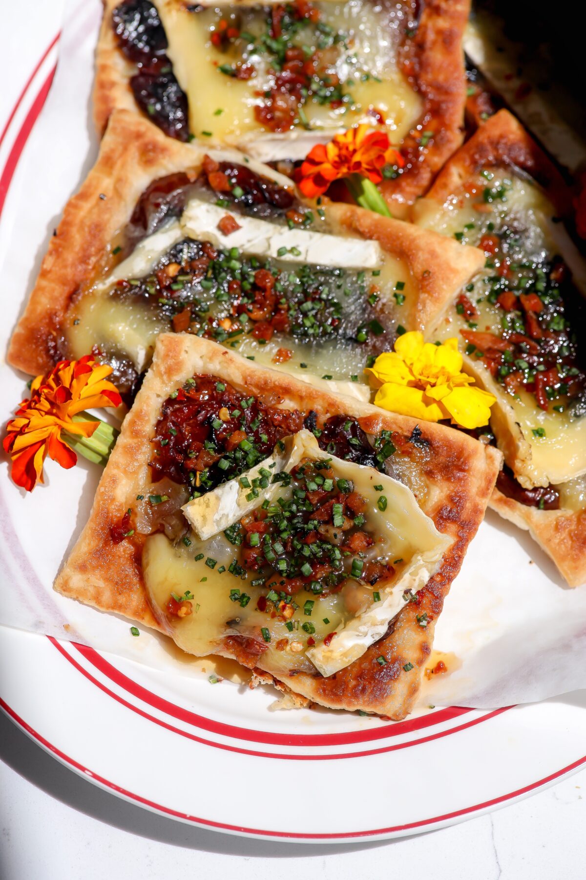 Sweet date fruit caramelized with melty brie cheese on a buttery flaky puff pastry making a delicious upside-down tart.