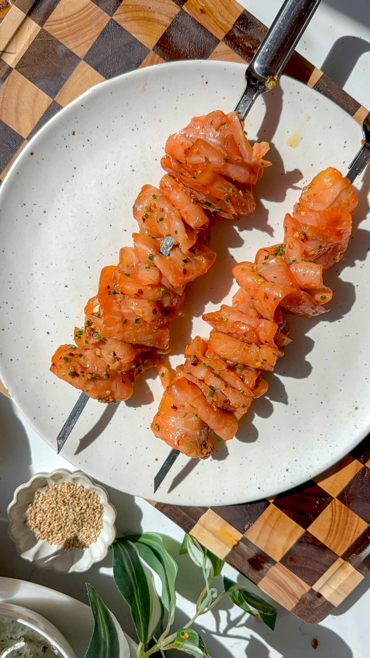 marinated smoked salmon on skewers on a plate.
