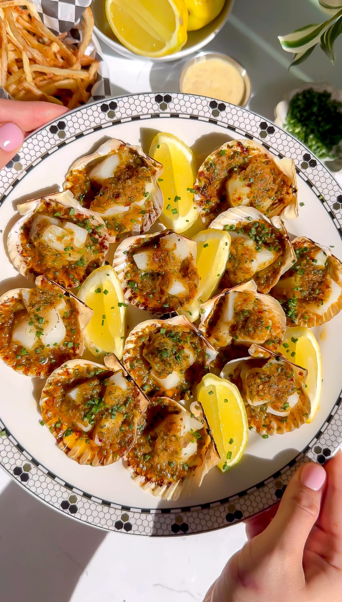 A recipe for scallops that have been broiled in a cute shell served with frites.