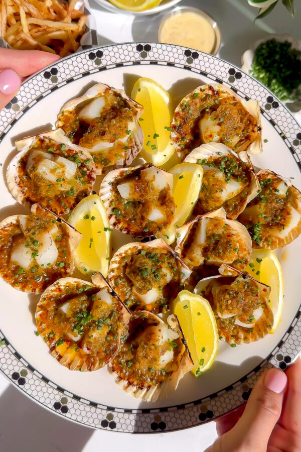 A recipe for scallops that have been broiled in a cute shell served with frites.