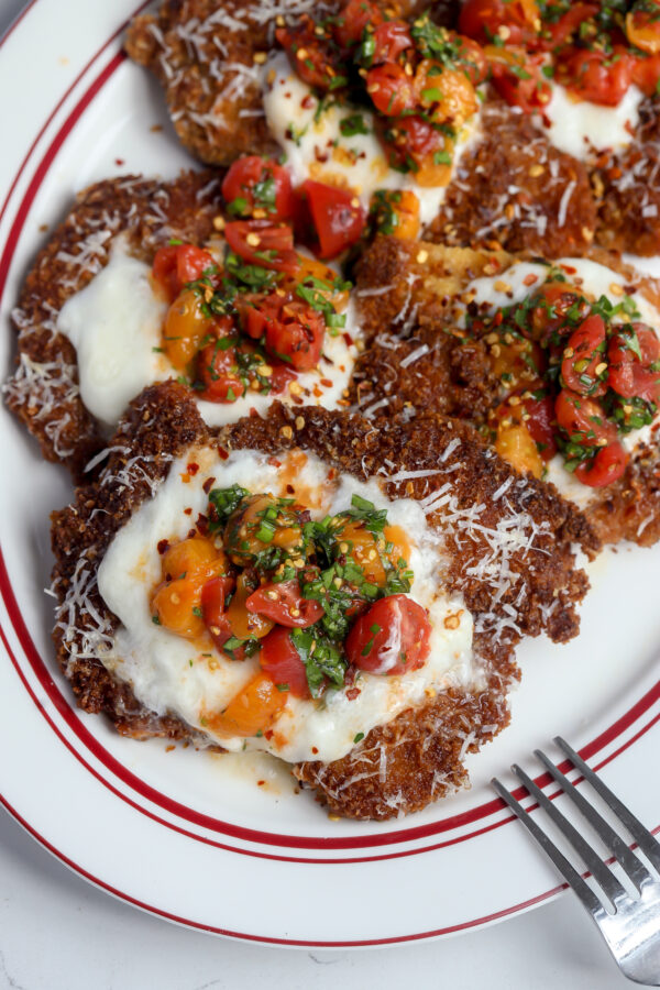 This is a recipe for Chicken Parm with Burrata and Tomatoes on top.