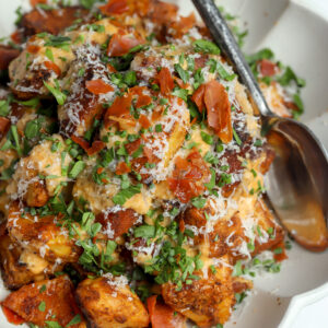 A recipe for Crispy Manchego Potatoes covered in a Creamy Chipotle Sauce, parm and chives.