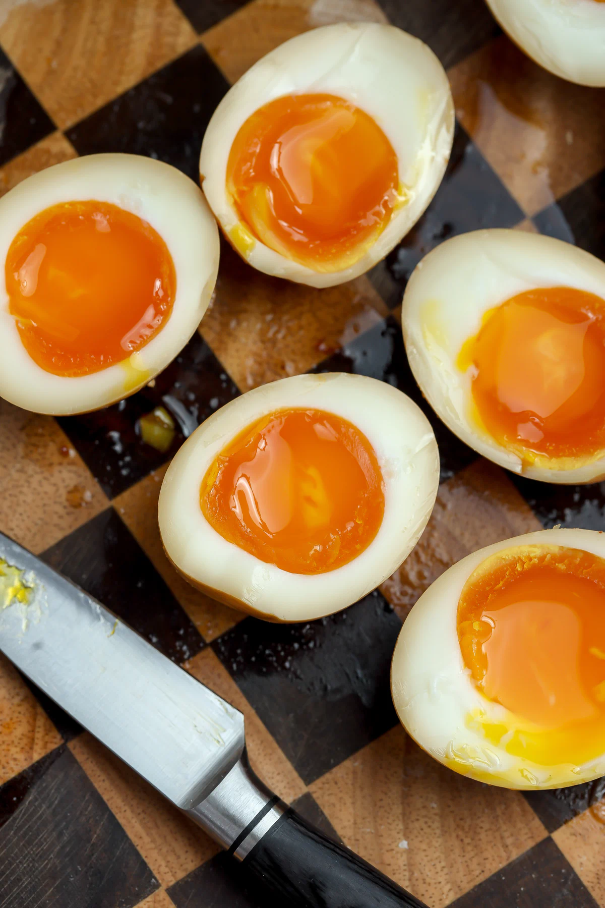 A recipe for perfectly cooked jammy eggs cut in half and ready to be placed in a ramen soup.