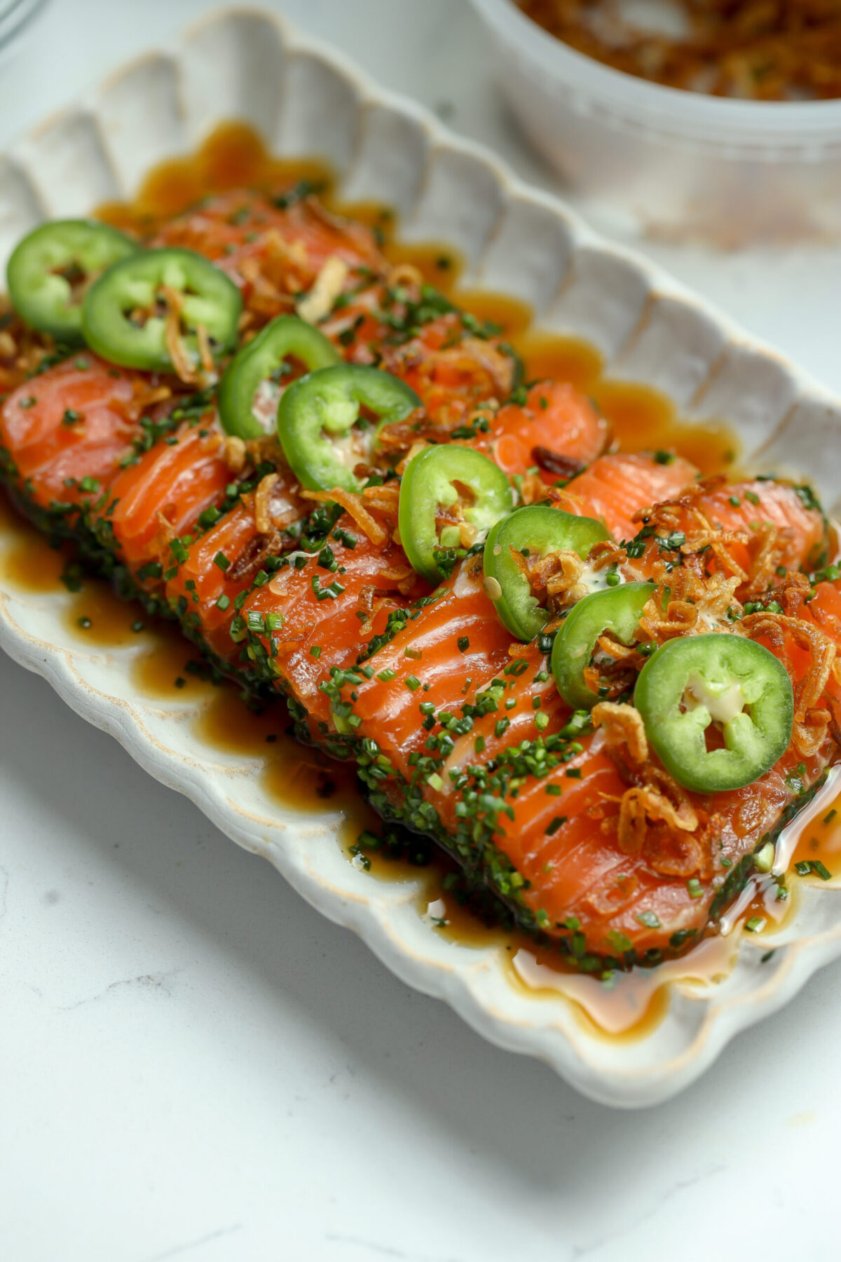 Salmon crudo recipe with yuzu soy dressing, spicy mayo, jalapeño, and crispy shallots — a light and flavorful chive-crusted crudo appetizer.