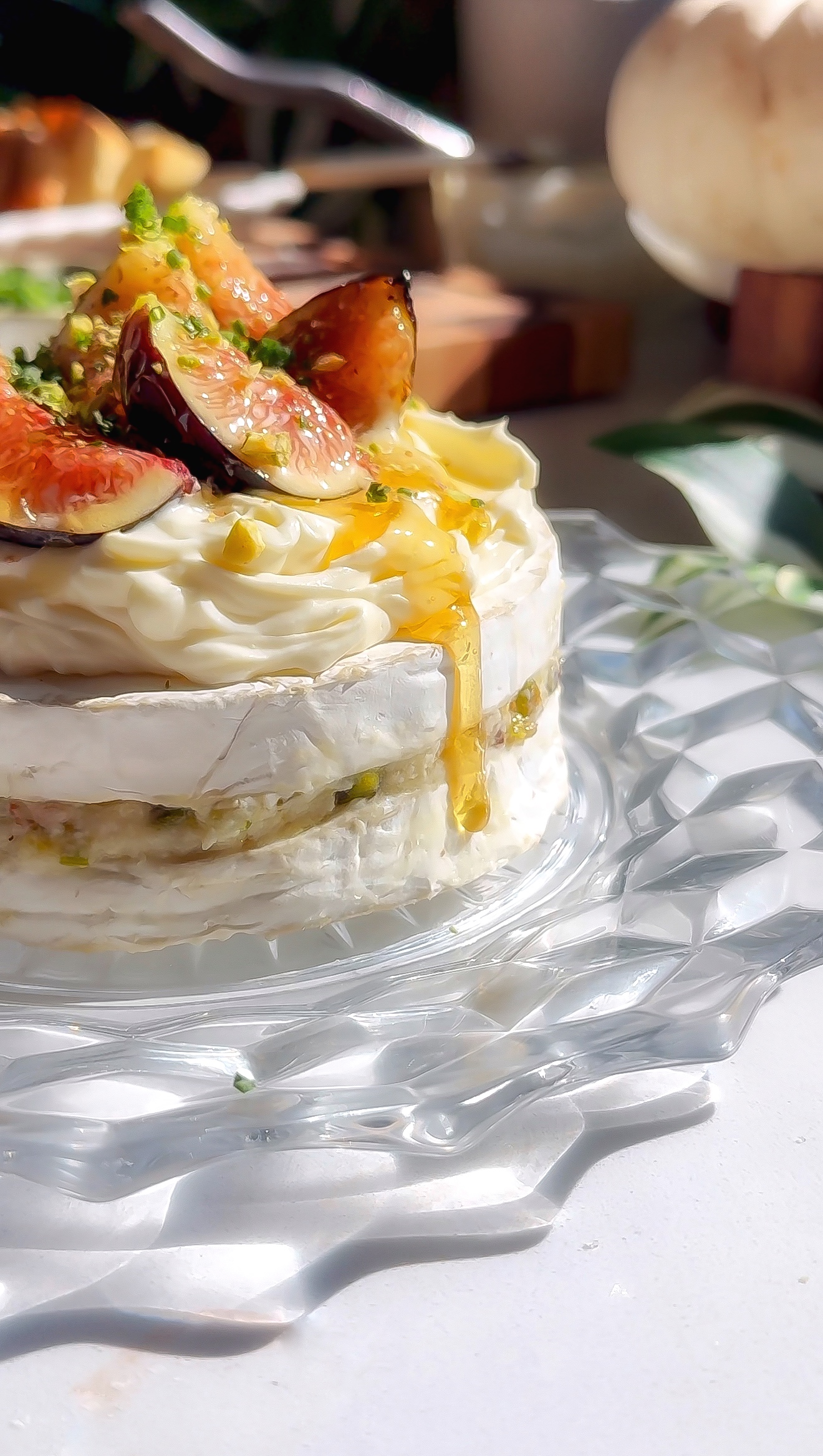 Toasted baguette dipping into whipped brie with figs, pistachios, and honey drizzle.