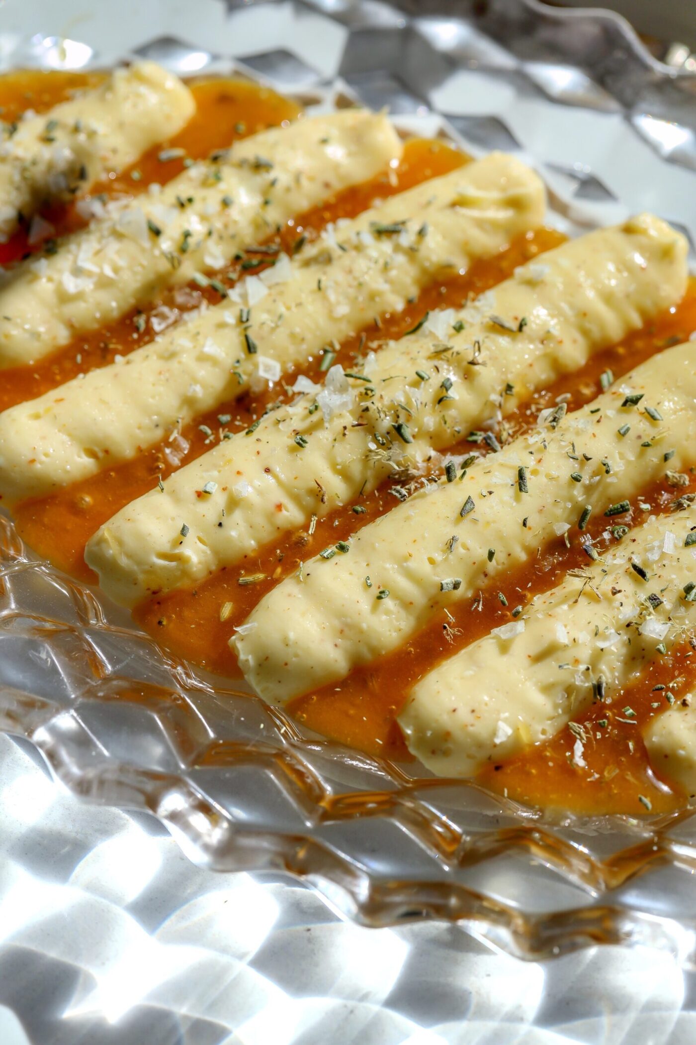 Whipped brie appetizer piped over a layer of creamed lavender honey, topped with rosemary and flaky salt.