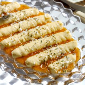 Whipped brie appetizer on a platter with creamed lavender honey, rosemary, and flaky salt, ready to serve with warm bread.