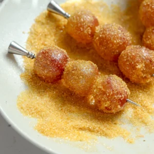 Lemon sugar coated boozy grapes skewered on cocktail picks with a sparkling finish.