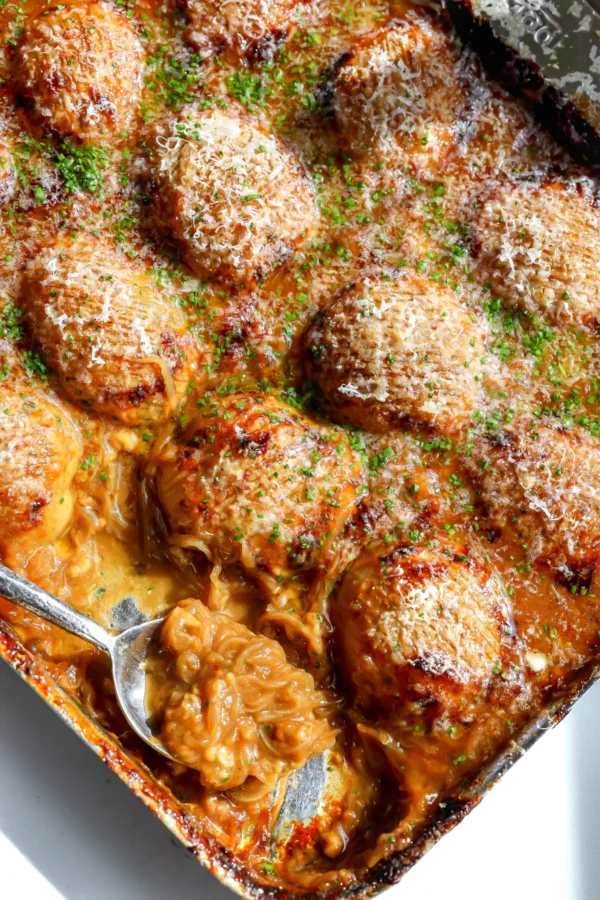 French onion hasselback potatoes baked in rich onion gravy with melted cheese and chives