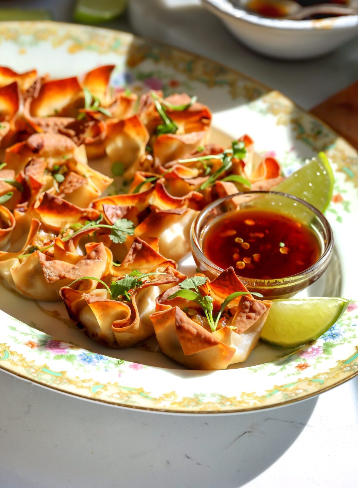 Pork and shrimp wonton cup appetizer baked until crisp and served with a savory dipping sauce