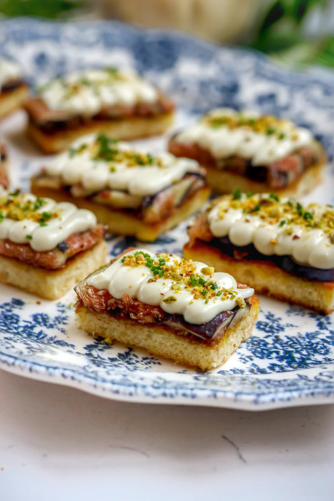 Fig toast with whipped brie, honey, and crushed pistachios on fried brioche